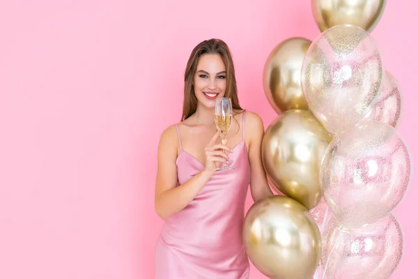Foto de mujer feliz levanta una copa de champán y muchos globos de aire. vino a la fiesta. Celebración — Foto de Stock