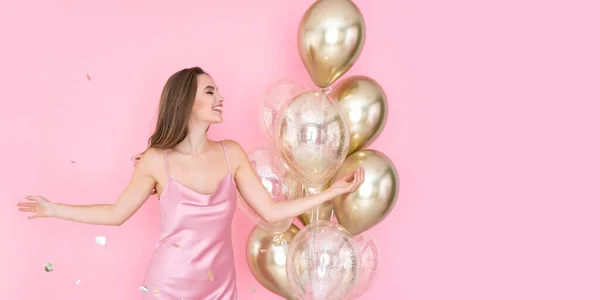 Feliz chica positiva celebra el Año Nuevo o la fiesta de cumpleaños feliz con globos de aire lanzando confeti. — Foto de Stock