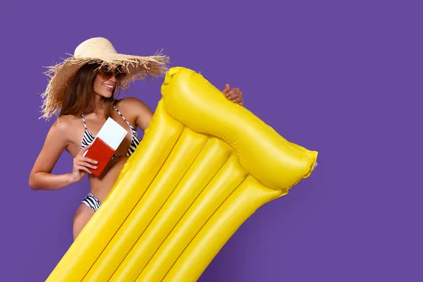 stock image Happy Girl ready to summer vacations stands with yellow inflatable mattress holds tickets, passport 