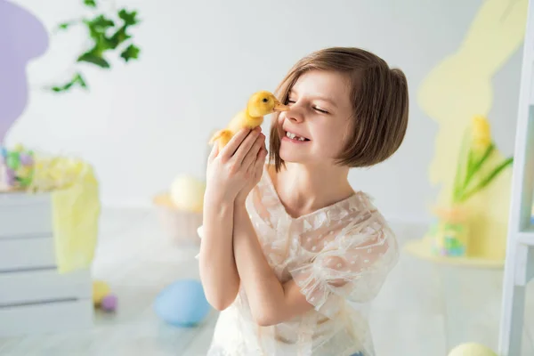 Portrait of Little girl who plays and communicates with duckling Easter decorations. Happy Easter — стокове фото
