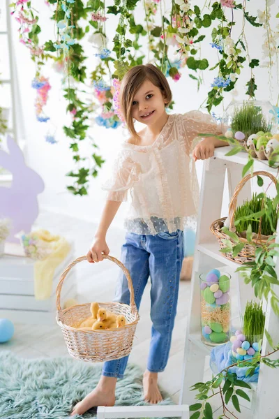 Half length of happy girl who holds basket with fluffy ducklings. Easter decorations. Happy Easter — Stock Photo, Image