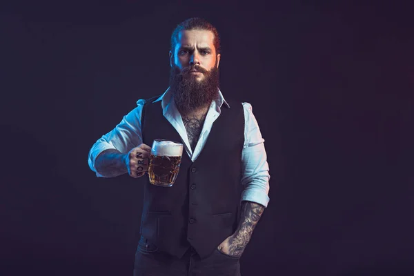 Half length of Bearded man who holds mug of beer looking at camera over black background — Zdjęcie stockowe