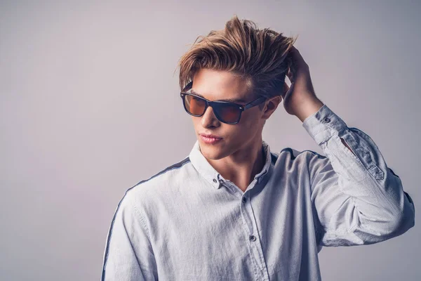 Male hairstyle concept. Handsome man with stylish haircut in sunglasses over white background — Stock Photo, Image