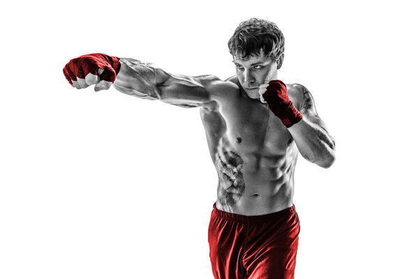 Portrait of Male boxer training and practicing jab. Isolated on white studio background. Concept of sport, healthy lifestyle. Black and white. Red sportswear