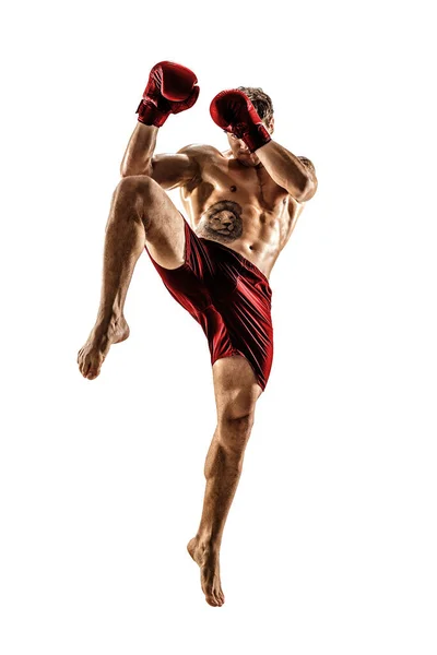 Full size of male kickboxer in red sportswear on white background. muscular athlete fighting — Stock Photo, Image