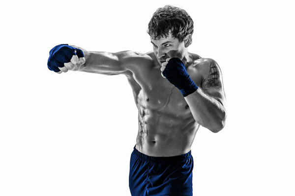 Studio Portrait of aggressive kickboxer training and practicing jab. Isolated on white studio background. Concept of sport, healthy lifestyle. Blue sportswear. Black and white silhouette