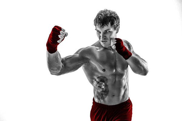 Portrait of aggressive silhouette boxer training and practicing uppercut. Isolated on white studio background. Concept of sport, healthy lifestyle. Red sportswear. Black and white