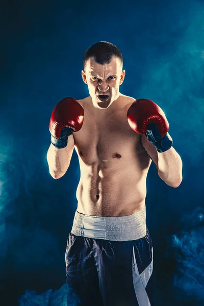 Retrato de boxeador emocional en guantes de boxeo rojos que aislado sobre fondo de humo negro — Foto de Stock