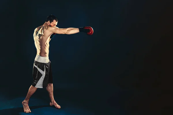 Concepção de fitness e boxe. Boxer, homem lutando ou posando em luvas em fundo escuro. Recreação esportiva individual — Fotografia de Stock