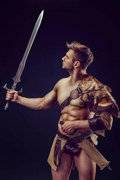 Portrait Handsome Muscular Gladiator Sword Isolated Studio Shot Dark Background — ストック写真