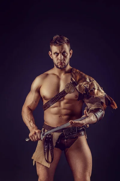 Portrait Handsome Muscular Gladiator Sword Isolated Studio Shot Dark Background — Stockfoto