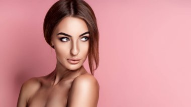 Close up portrait of tender cute gorgeous gentle perfect facial skin girl isolated on rose background. 