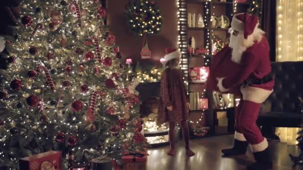 Santa Clause His Little Helper Tiptoe Christmas Tree Put Gifts — Stock Video