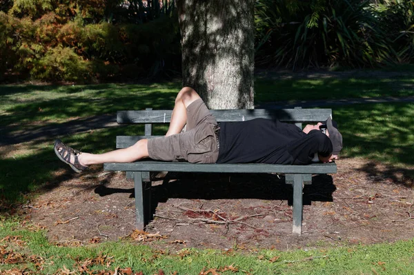 Dappled Light Tree Provides Shade Older Man Lying Park Bench — Fotografia de Stock