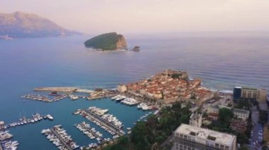 Budva 'nın eski şehri ve arka plandaki Aziz Nicholas adasının insansız hava aracı görüntüsü