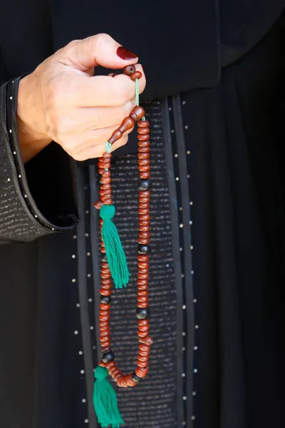 Muslim woman holding prayer beads United Arab Emirates.