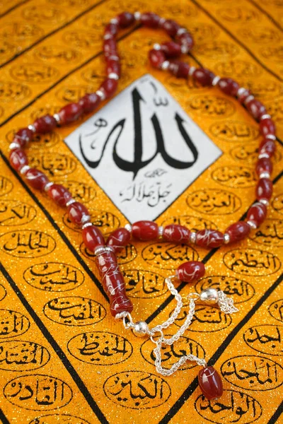 Symbols of Islam. Prayer beads and Allah caligraphy.  France.