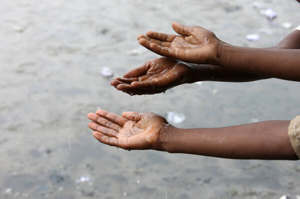 Rainy season. Children playing with water.  Congo Brazzaville. 