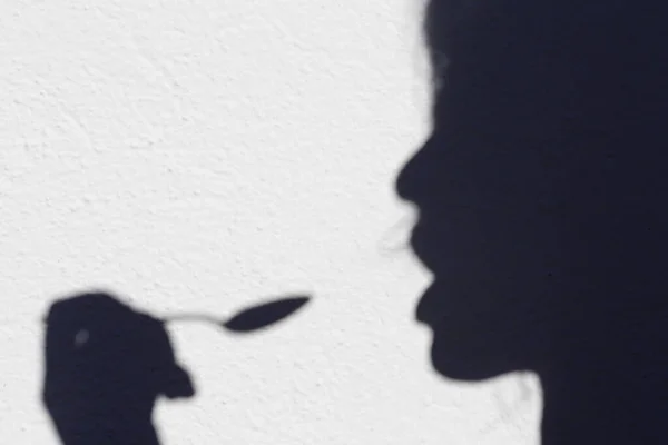 Shadow Woman Eating Spoon — стоковое фото