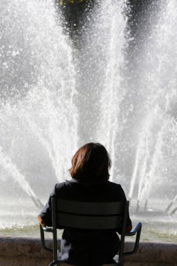 Sad Woman sitting on chair.   France. 