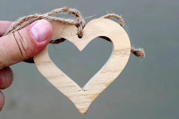Man Holding Wooden Heart Close — Stock Photo, Image