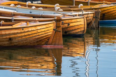 Traditional wooden rowboats lined up in the harbor.