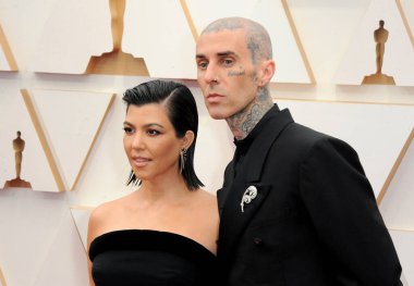Kourtney Kardashian and Travis Barker at the 94th Annual Academy Awards held at the Dolby Theatre in Los Angeles, USA on March 27, 2022. clipart