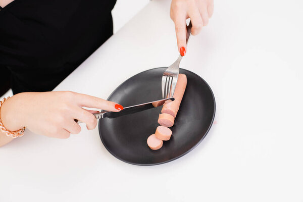 beautiful girl eating sausage and smile