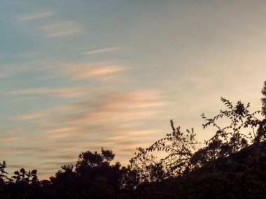 Long-exposure of soft clouds with the light of the foreglow over the eastern Andes range mountains of central Colombia near the colonial town of Villa de Leyva.