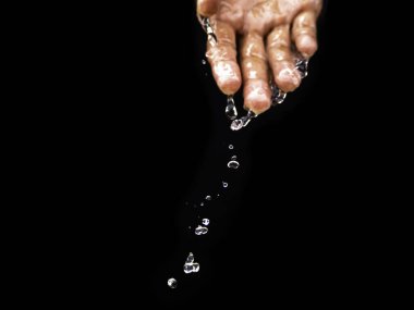 Water flows on the palm of the hand down below. The purity of the water.The benefits of water. conditions of drought and natural disasters.