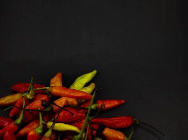 Siyah arka planda izole edilmiş bir demet kırmızı biber fotoğrafı.