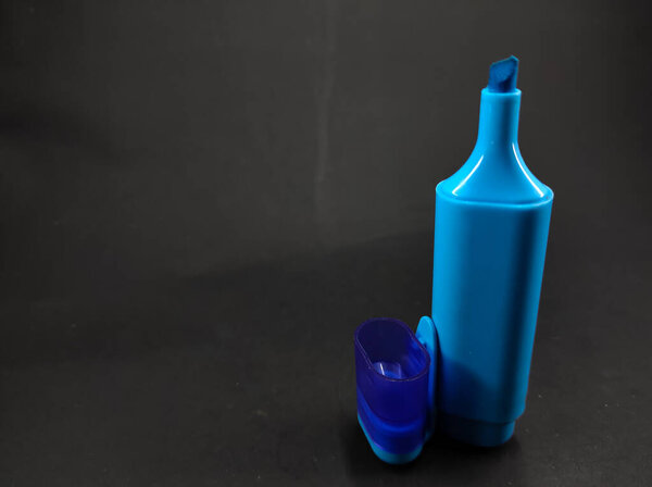 Photo of blue highlighter isolated on black background