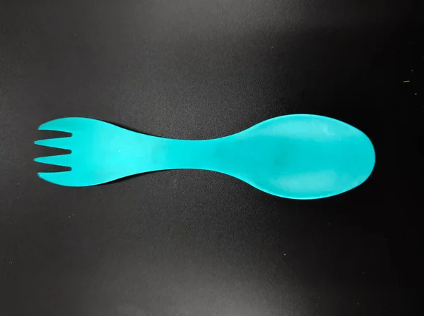 Photo Light Blue Fork Spoon One Isolated Black Background Focus — Fotografia de Stock