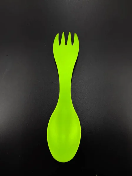 Photo Light Green Fork Spoon One Isolated Black Background Focus — Zdjęcie stockowe