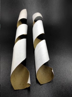 Photo of a white cardboard spiral isolated on a black background, Not Focus