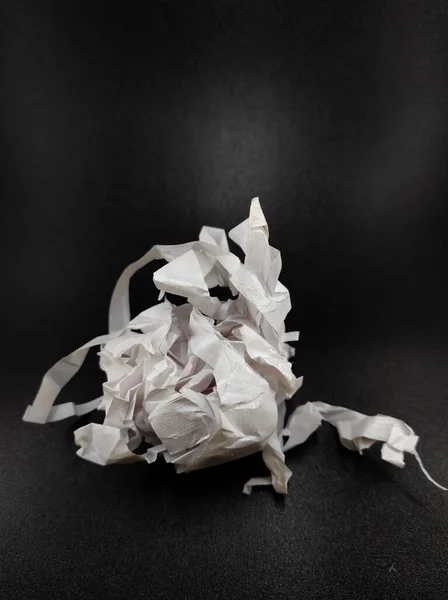 Photo White Torn Paper Bundle Isolated Black Background Out Focus — стоковое фото