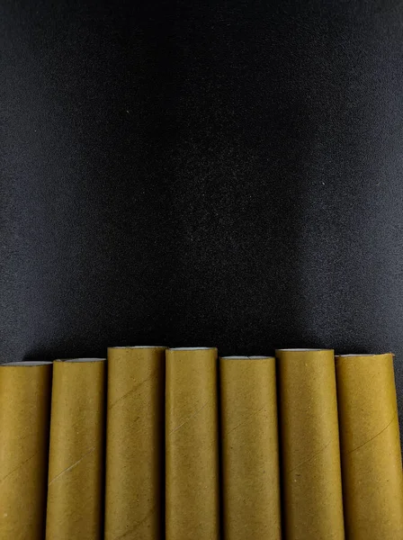 Photo Brown Cardboard Rolls Row Isolated Black Background Focus — Stock Fotó