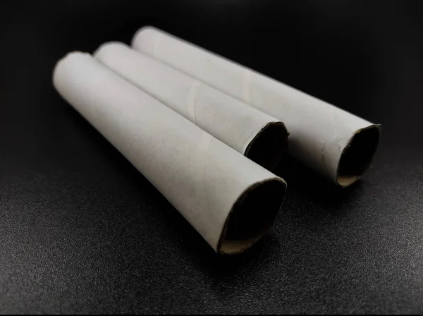 Photo White Cardboard Rolls Row Isolated Black Background Focus — Stock Fotó