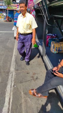 Bandung, West Java, Indonesia - January 04, 2022: Photo of passengers loading their luggage into the trunk of a bus at the Cicaheum terminal, Indonesia
