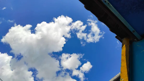 Una Colección Nubes Durante Día Detrás Sombra Del Techo Casa —  Fotos de Stock
