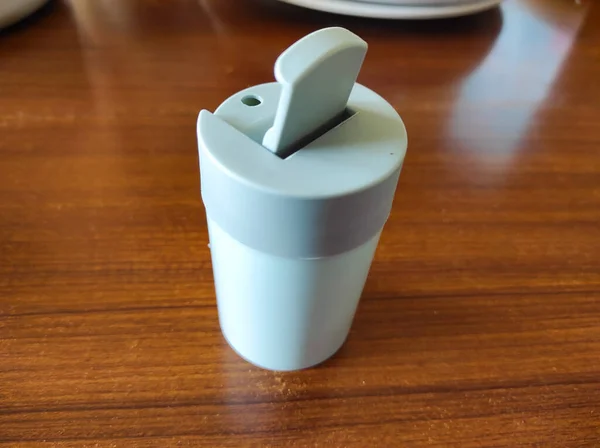 A toothpick container on a brown table at a restaurant in Pangandaran, Indonesia