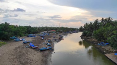 Endonezya 'nın Pangandaran bölgesinde nehir kıyısında balıkçı tekneleriyle dolu bir nehir.