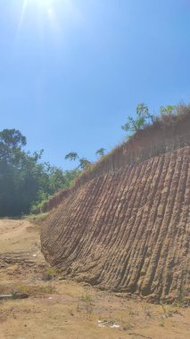 Abstract Defocused Blurred Background of the soil at the construction site during the day, which has a line pattern from excavations on the soil surface in the Cikancung area - Indonesia