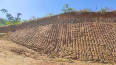 Abstract Defocused Blurred Background of the soil at the construction site during the day, which has a line pattern from excavations on the soil surface in the Cikancung area - Indonesia