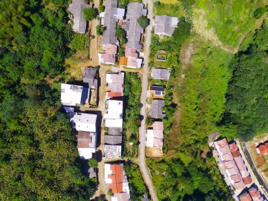 Abstract Defocused Blurred Background Aerial photography a view of a remote residential area in the middle of a forest and mountain slope in the Cikancung area - Indonesia. Not Focus