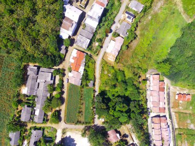Abstract Defocused Blurred Background Aerial photography a view of a remote residential area in the middle of a forest and mountain slope in the Cikancung area - Indonesia. Not Focus