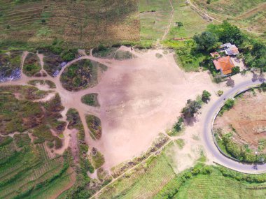 Abstract Defocused Blurred Background Scenic view of a road bend at the top of a hill, covered by cloud shadows in Cicalengka area - Indonesia. Not Focus