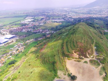 Abstract Defocused Blurred Background Scenic view Stunning green hills, covered by cloud shadows in Cicalengka area - Indonesia. Not Focus