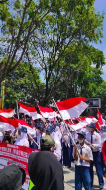 Cicalengka, West Java, Indonesia - 17 August, 2022 : Defocused and Blur Photo of a high school marching band taking part in the Indonesian Independence festival while carrying a decorated stretcher. Not Focus