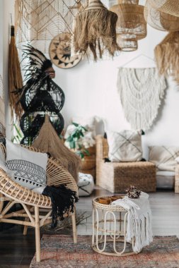 Samimi bir kafeye ya da etnik iç tasarımı olan bir oturma odasına dikey bir bakış. Ev dekorasyonu, mobilya, yastık, koltuk, bambu kahve sehpası ile bohem stili kavramı.